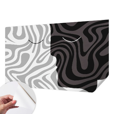 Stick-on wall mural with an abstract faces design