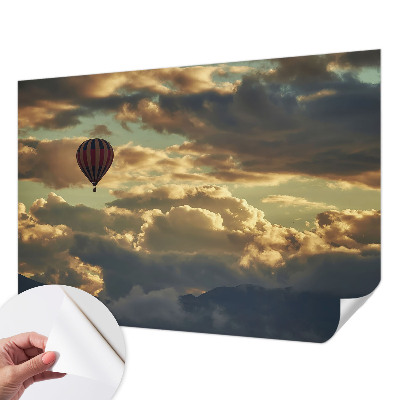 Nursery wall mural with a balloon floating among the clouds
