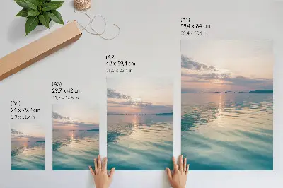 Poster calm water surface with a bridge reflecting warm sky colors