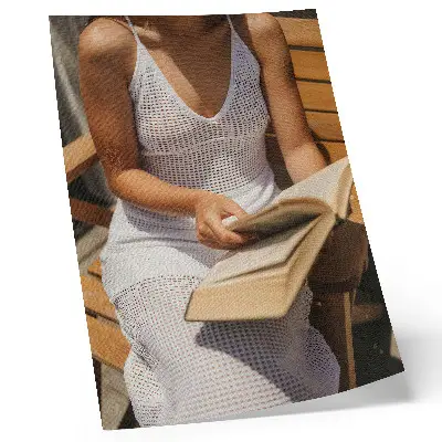 Premium wall art woman with a book on a wooden bench in the sunlight