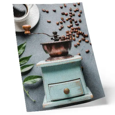 Decorative poster old turquoise coffee grinder with coffee beans and green leaves