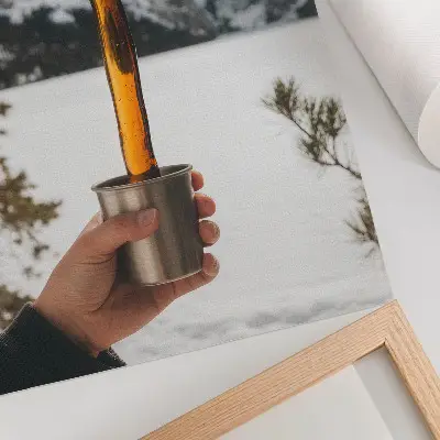 Art print featuring a mountain landscape with amber snow and a mug