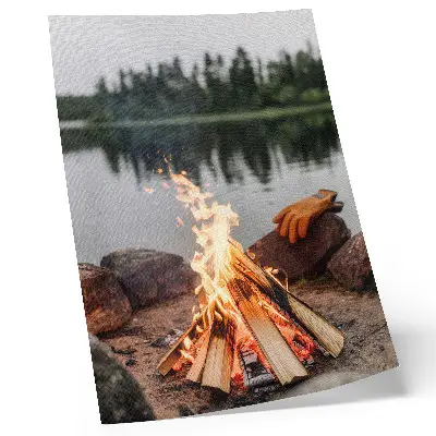 Decorative poster featuring a bonfire by a serene forest lake with stones