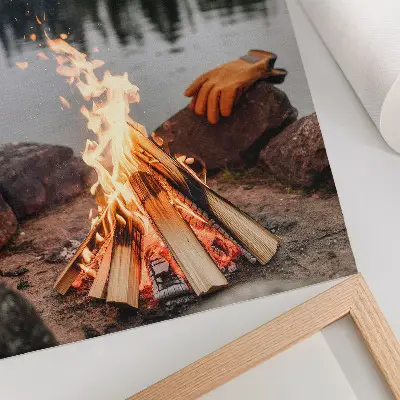 Decorative poster featuring a bonfire by a serene forest lake with stones