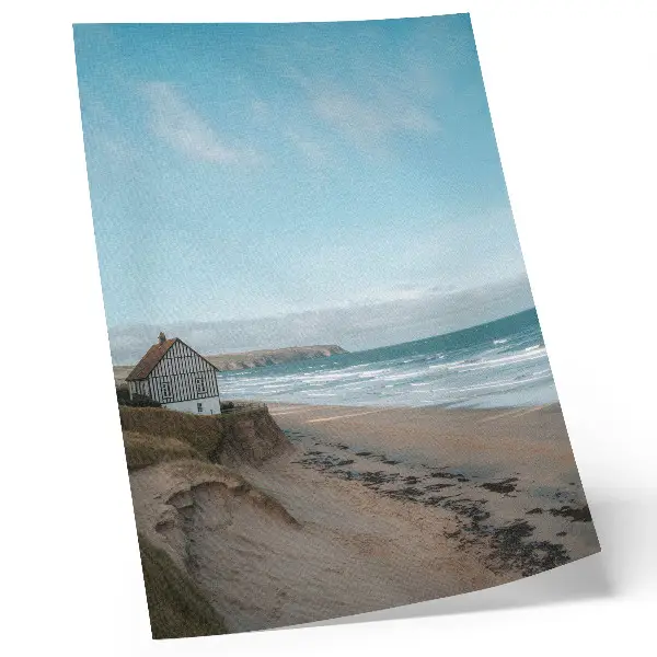 Poster beach with waves and a house on a cliff in pastel colors