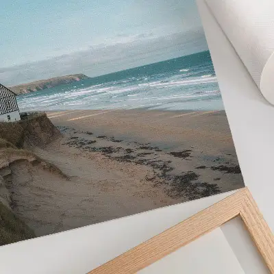 Poster beach with waves and a house on a cliff in pastel colors