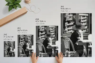 Art print woman wearing a hat at a table in a cafe