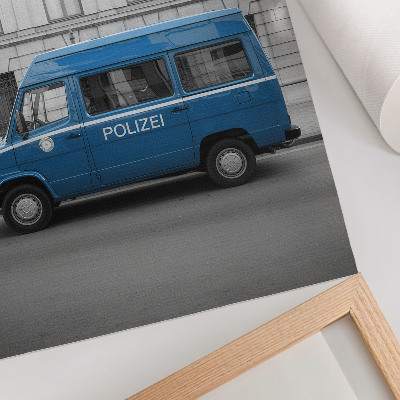 Poster A blue police car with a building in the background