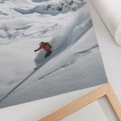 Premium wall art skier in action against a blue sky in the white mountains