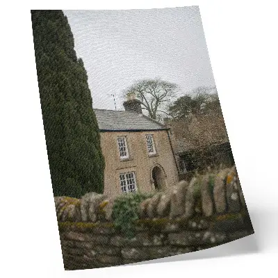 Premium decorative wall art featuring a cozy home among trees with a stone fence in a peaceful setting