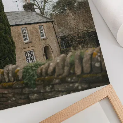 Premium decorative wall art featuring a cozy home among trees with a stone fence in a peaceful setting