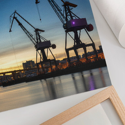 Poster Cranes against the backdrop of a dynamic sunset scenery