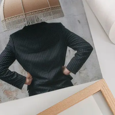 Art print featuring a refined lampshade and an elegant suit in a contrast of textures