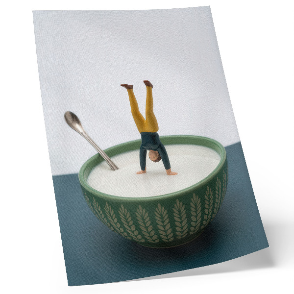 Poster Figurine in a bowl of milk with green leaves
