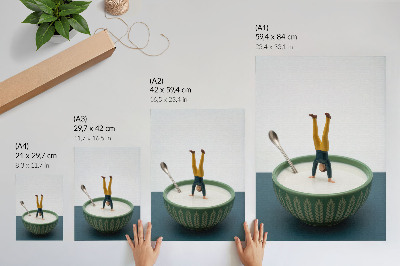 Poster Figurine in a bowl of milk with green leaves