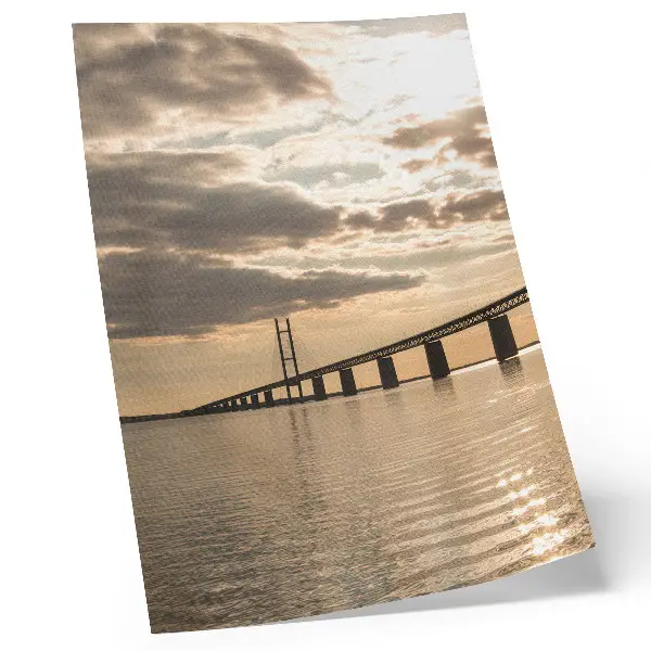 Poster a bridge over the water at sunset