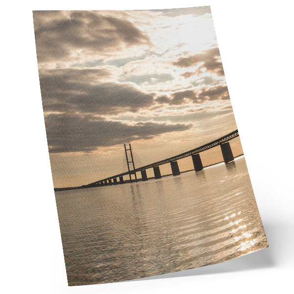 Poster A bridge over the water in the light of the setting sun