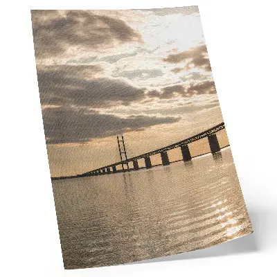 Poster a bridge over the water at sunset