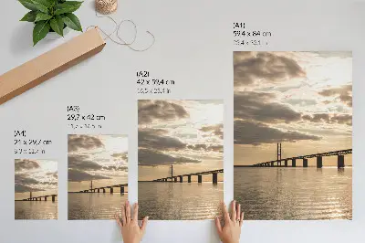 Poster a bridge over the water at sunset