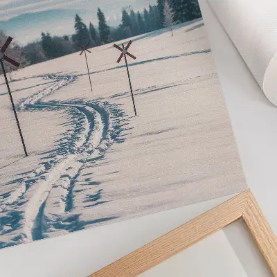 Poster winter landscape with ski tracks, mountains, trees, and sky