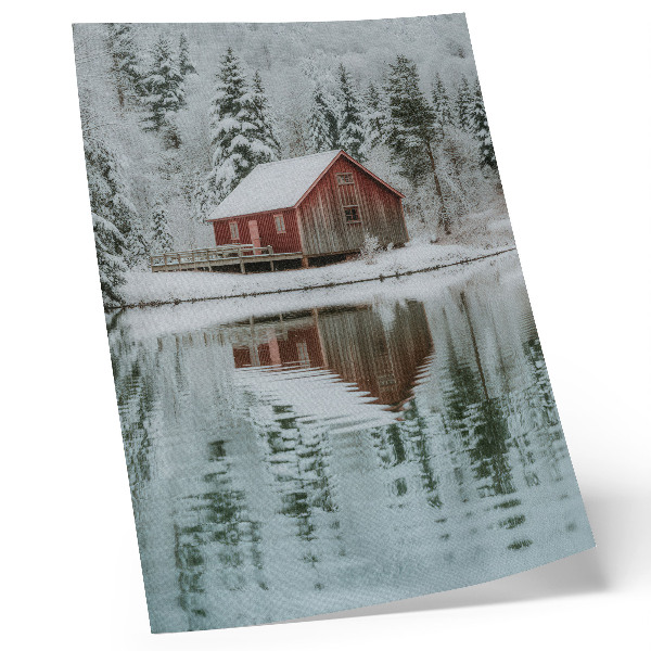 Art print A red cottage among snowy trees by the water
