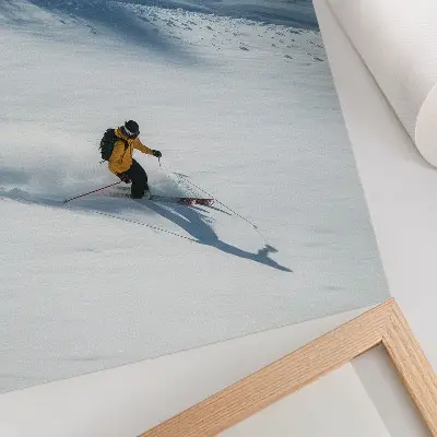 Poster skier in a yellow jacket on a snowy slope with a shadow