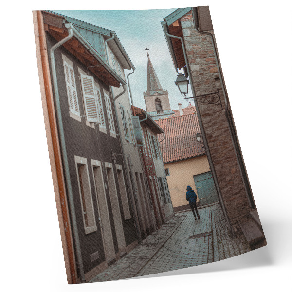 Poster Narrow street, tenement houses, tower, blue coat