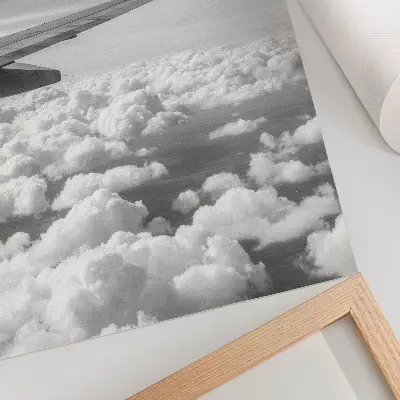 Decorative poster airplane wing above the clouds in black and white