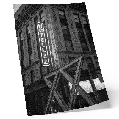Black and white architectural wall art with neon hotel lights
