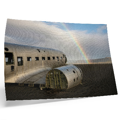 Decorative canvas print featuring a metal plane wreck with a rainbow in the background