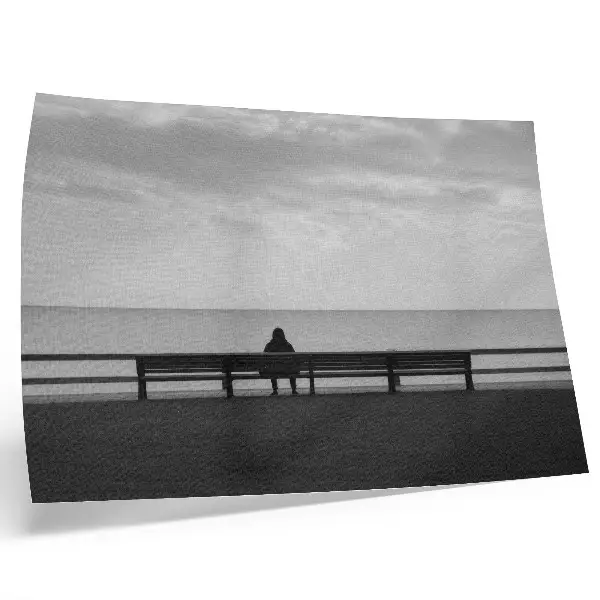 Decorative canvas print person on a bench by the sea in gray harmony