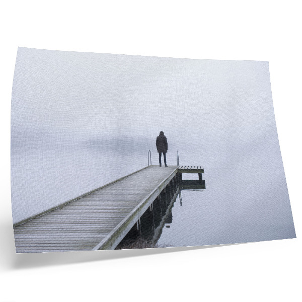 Photo canvas A lonely figure on a pier in the fog