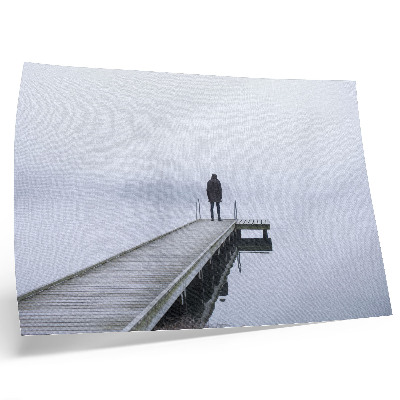 Photo canvas A lonely figure on a pier in the fog