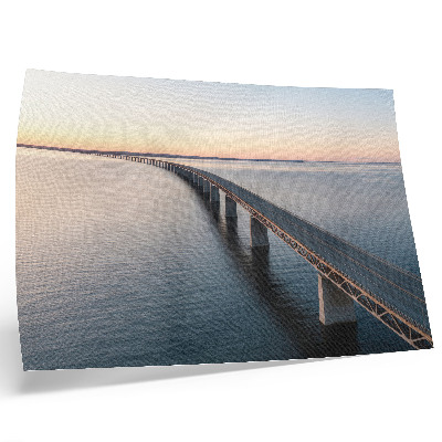 Decorative canvas print A bridge over a calm sea at sunset