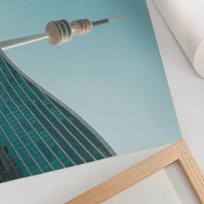 Decorative canvas print featuring a modern city tower against a blue sky