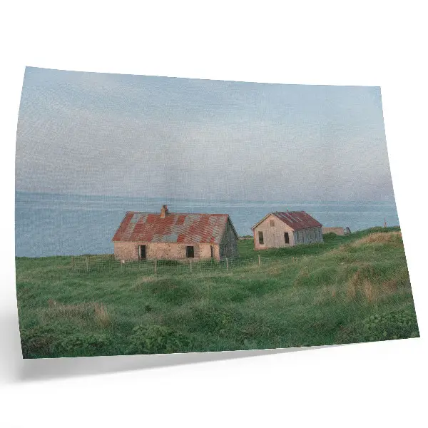 Poster rustic buildings with green meadows and the sea