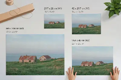 Poster rustic buildings with green meadows and the sea