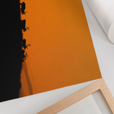Photo canvas Silhouettes of deer on a hill with an orange background