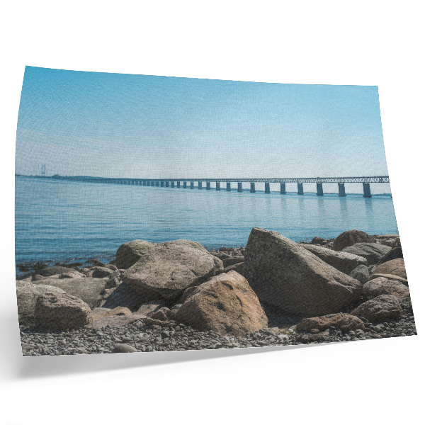 Decorative canvas print Bridge over blue water stones on the shore