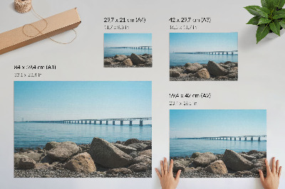 Decorative canvas print Bridge over blue water stones on the shore