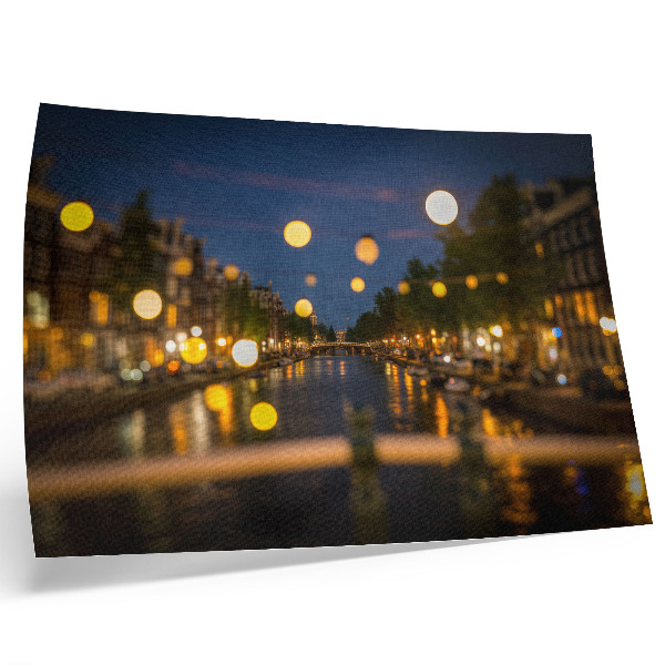 Poster A charming city at night, lights reflected in the water