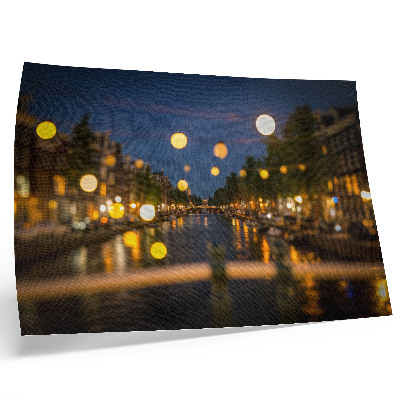 Poster A charming city at night, lights reflected in the water