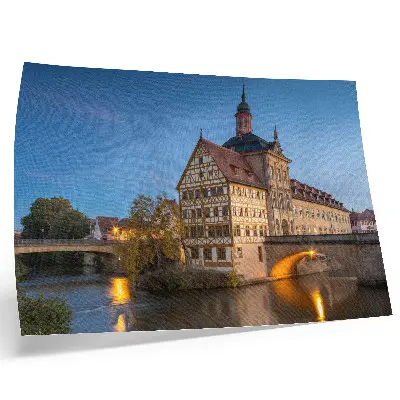 Decorative canvas print featuring a historic building by a water bridge under a blue sky