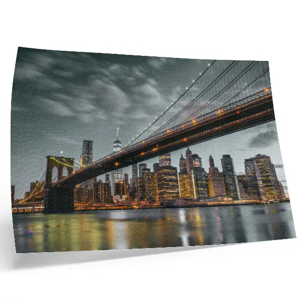 Poster panoramic evening city view with bridge, lights, and water