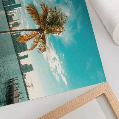 Photo canvas featuring palm trees by a calm lake under a turquoise sky with city skyscrapers