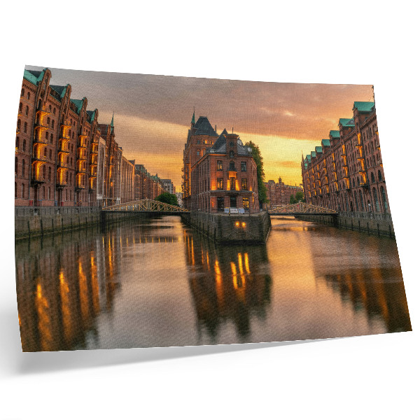 Decorative canvas print Calm water, brick buildings, warm light