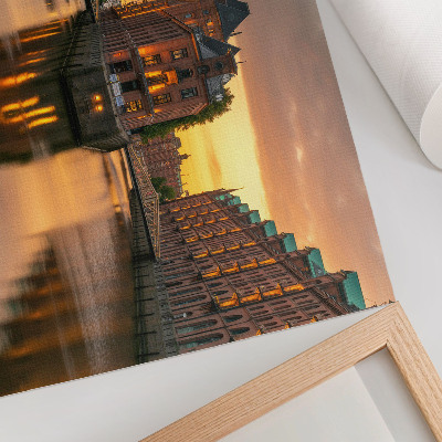 Decorative canvas print Calm water, brick buildings, warm light