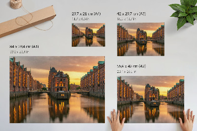 Decorative canvas print Calm water, brick buildings, warm light