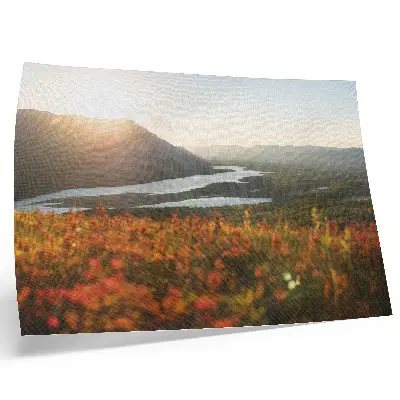 Poster featuring a peaceful sunset landscape with flowers, mountains, and a river