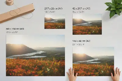 Poster featuring a peaceful sunset landscape with flowers, mountains, and a river